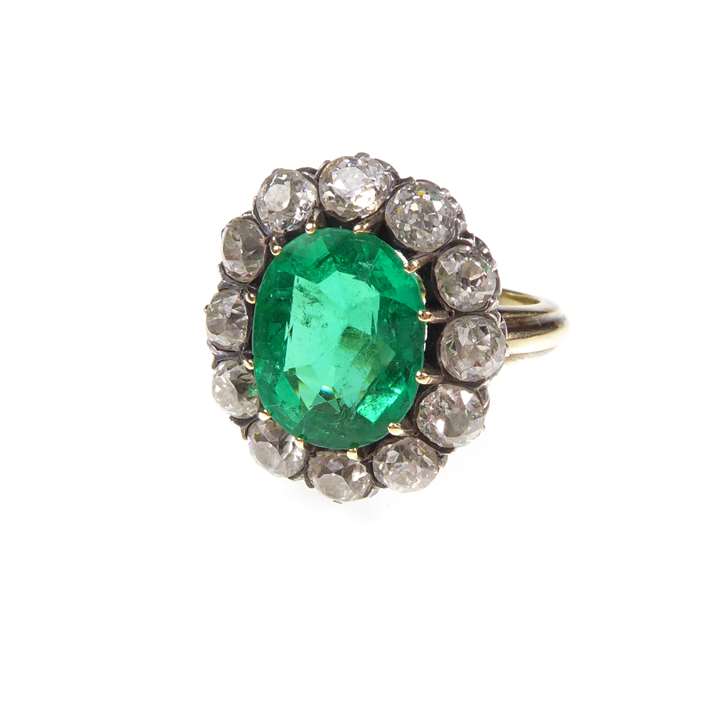Antique emerald and diamond cluster ring, claw set with a cushion cut emerald